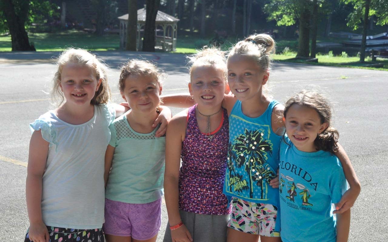 Five happy girl campers