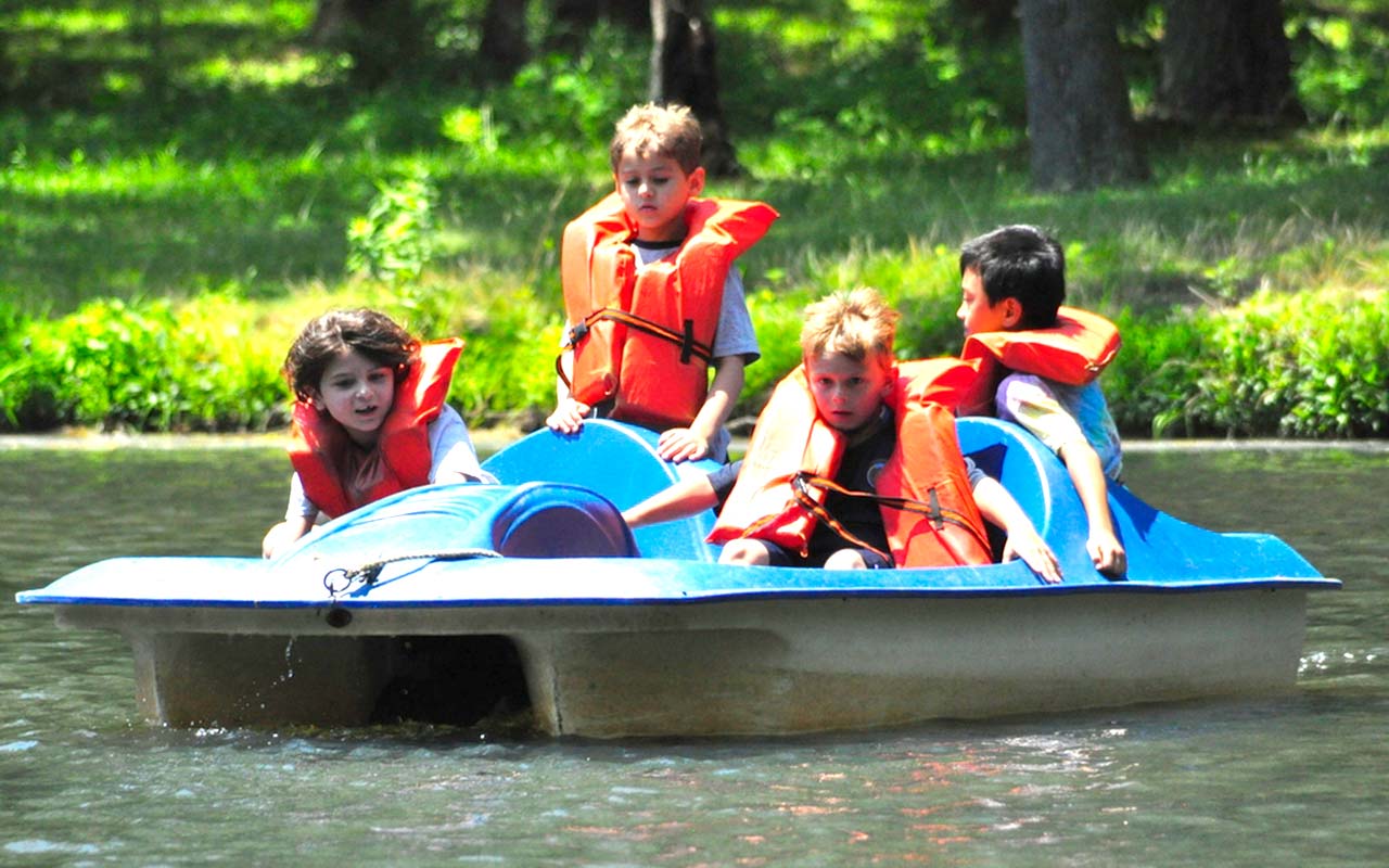 Campers in a paddle boat on the lake