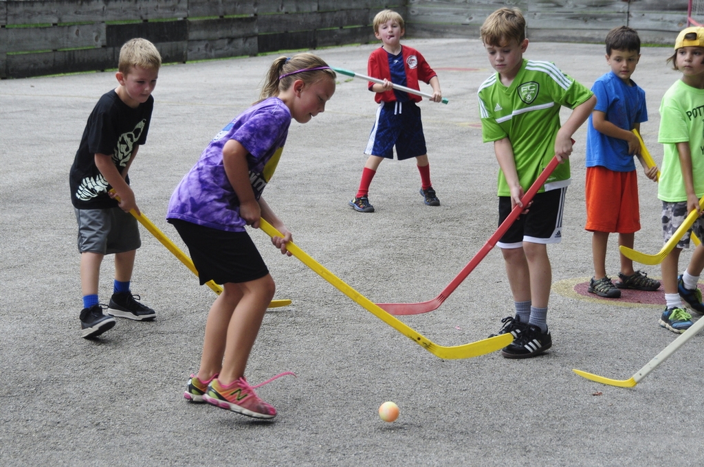 Campers playing street hockey